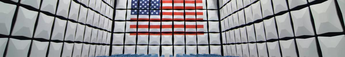 room with square boxes on wall. most boxes are white. some form a pattern of US flag